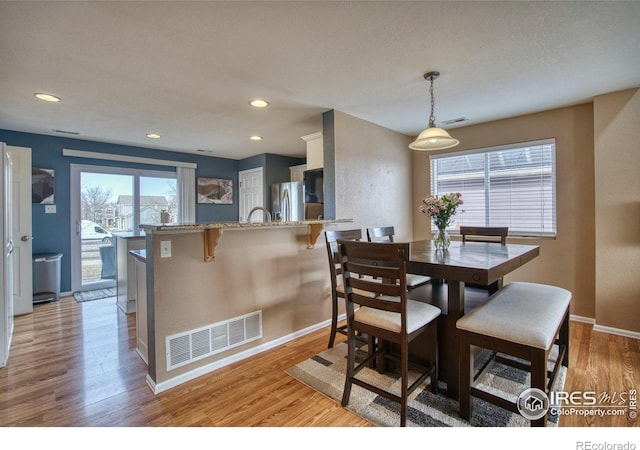 dining room featuring recessed lighting, light wood-style floors, visible vents, and baseboards