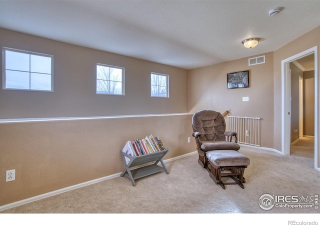 sitting room featuring visible vents, baseboards, and carpet