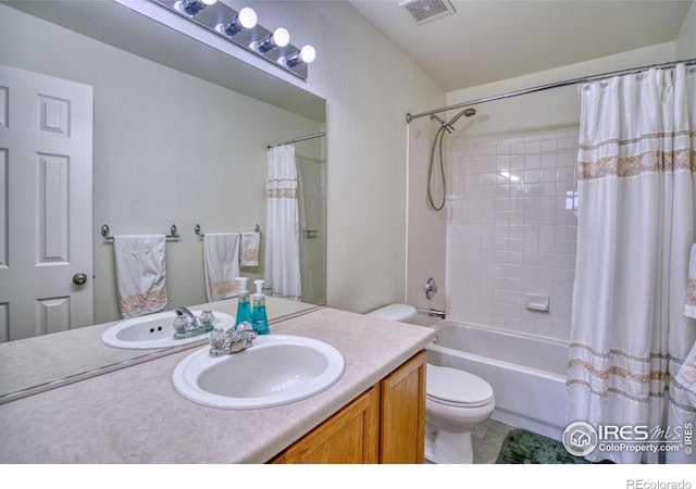 full bathroom with vanity, shower / bath combination with curtain, toilet, and visible vents