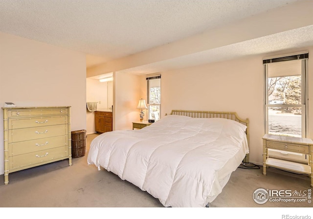 carpeted bedroom featuring multiple windows and a textured ceiling