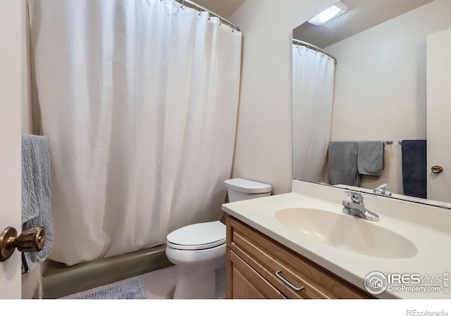 full bathroom featuring toilet, vanity, and tile patterned flooring