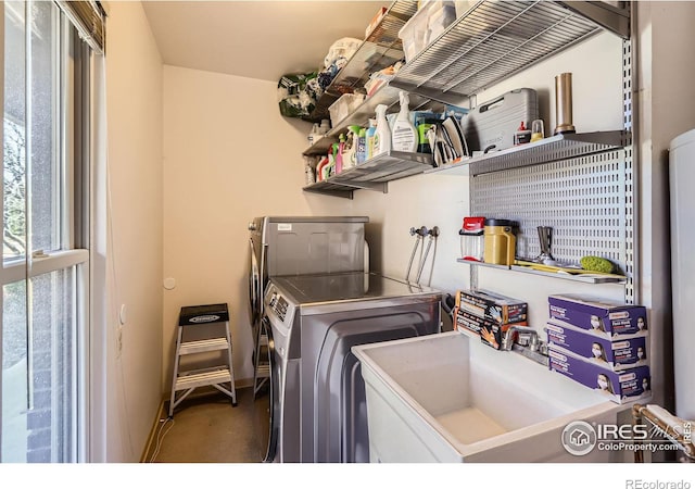 washroom with a sink, washing machine and dryer, and laundry area