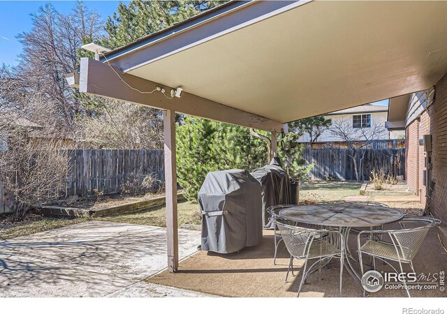 view of patio / terrace featuring outdoor dining area, a fenced backyard, and a grill