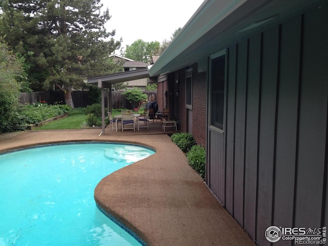 view of pool featuring a fenced in pool, fence, and a patio area