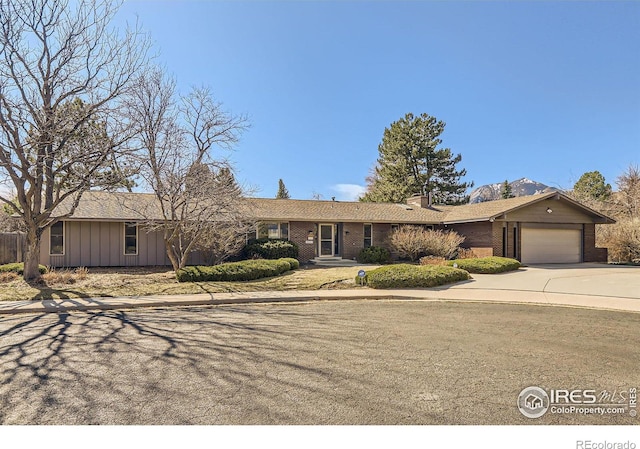 ranch-style house with brick siding, driveway, and a garage