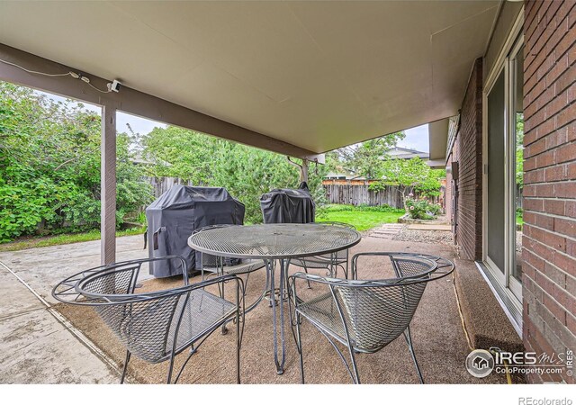 325 Fox Ct, Boulder, CO 80303 - fenced backyard featuring outdoor dining area, a patio, and area for grilling