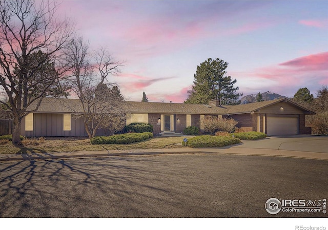 325 Fox Ct, Boulder, CO 80303 - single story home with a garage, concrete driveway, board and batten siding, and brick siding