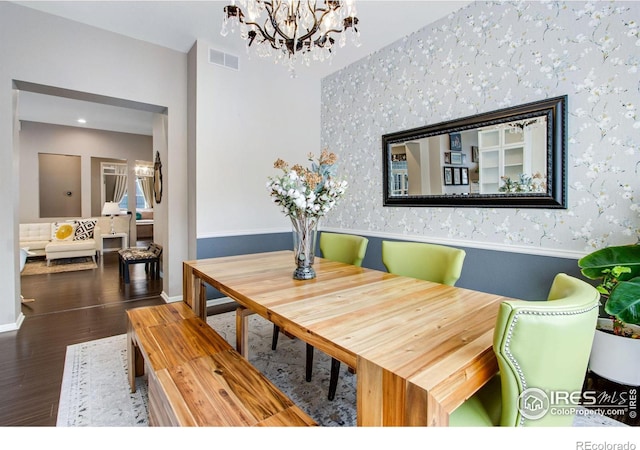 2073 River W Dr, Windsor, CO 80550 - dining room with wainscoting, visible vents, a chandelier, wallpapered walls, and wood finished floors