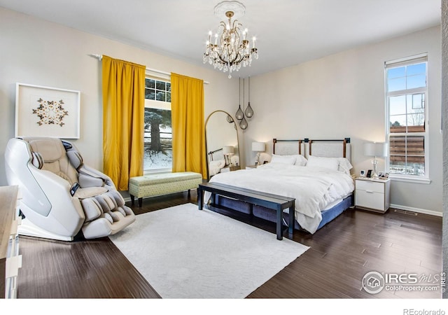 2073 River W Dr, Windsor, CO 80550 - bedroom featuring a chandelier, dark wood-style flooring, baseboards, and visible vents