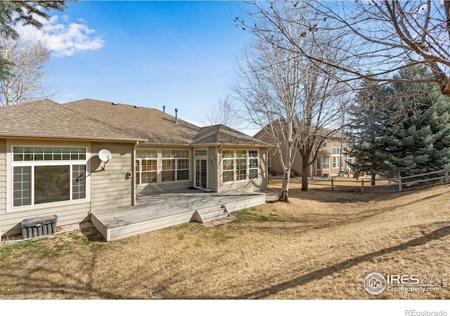 2073 River W Dr, Windsor, CO 80550 - rear view of house featuring a wooden deck, a lawn, a shingled roof, and fence
