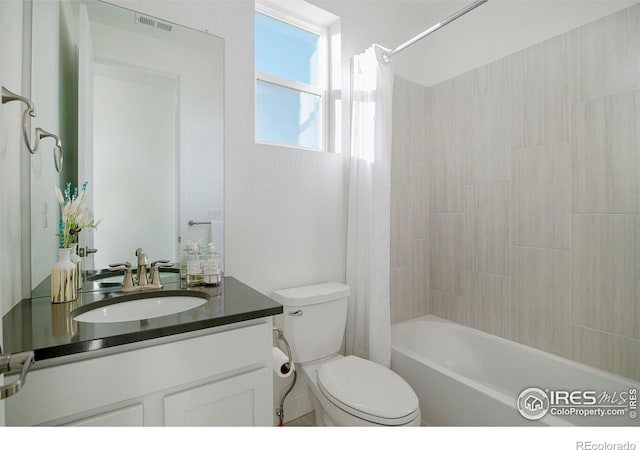 full bath with vanity, toilet, visible vents, and shower / tub combo with curtain