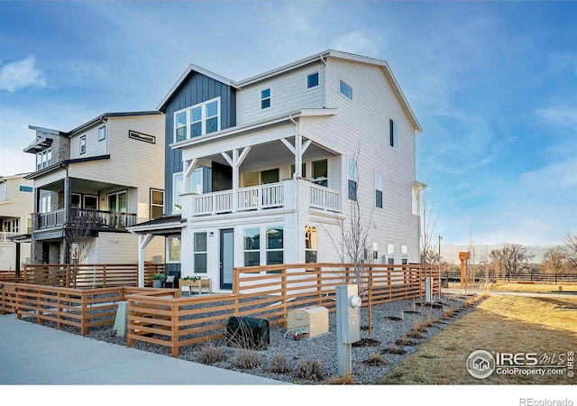 view of front of property with board and batten siding and fence