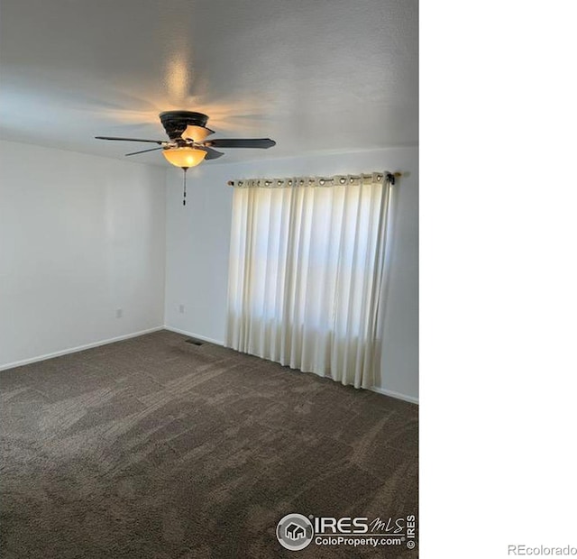 unfurnished room featuring visible vents, carpet, and a ceiling fan