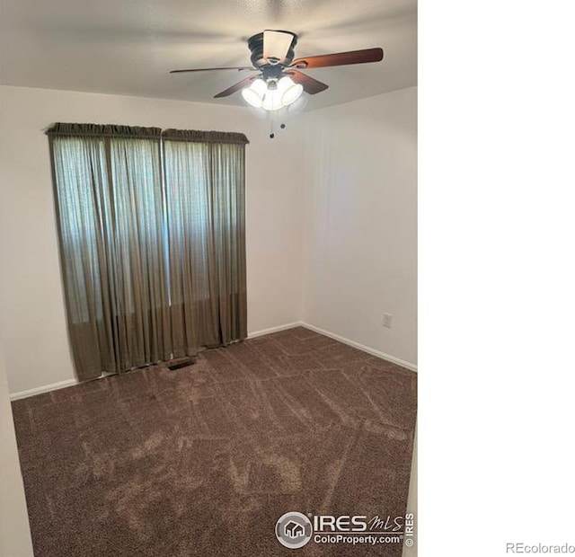 unfurnished room featuring visible vents, baseboards, carpet, and a ceiling fan