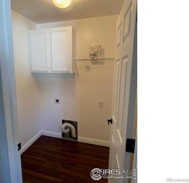 laundry room featuring dark wood finished floors, cabinet space, electric dryer hookup, and baseboards