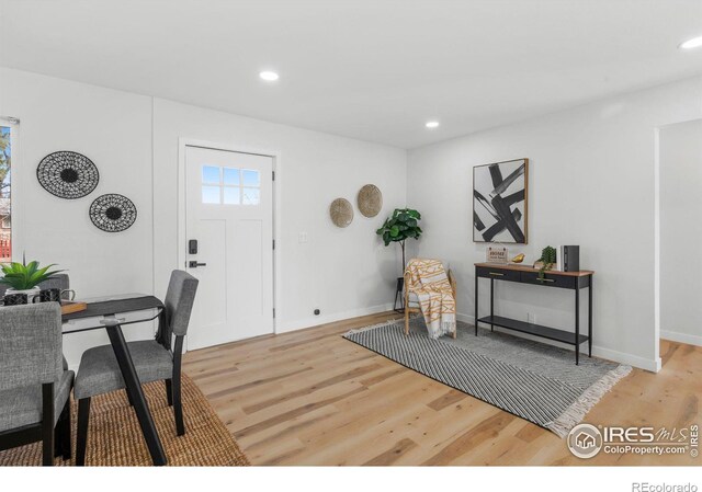 foyer entrance with recessed lighting, baseboards, and wood finished floors