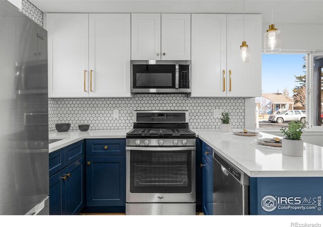 kitchen with white cabinetry, blue cabinetry, tasteful backsplash, and stainless steel appliances