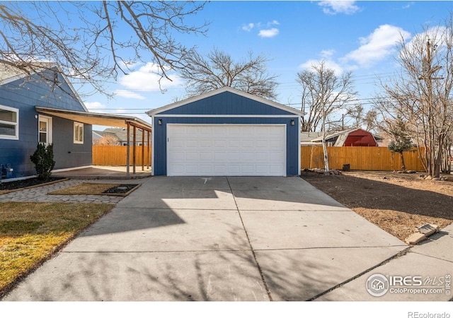 detached garage featuring fence