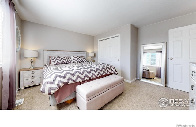 bedroom with baseboards, a closet, and carpet floors