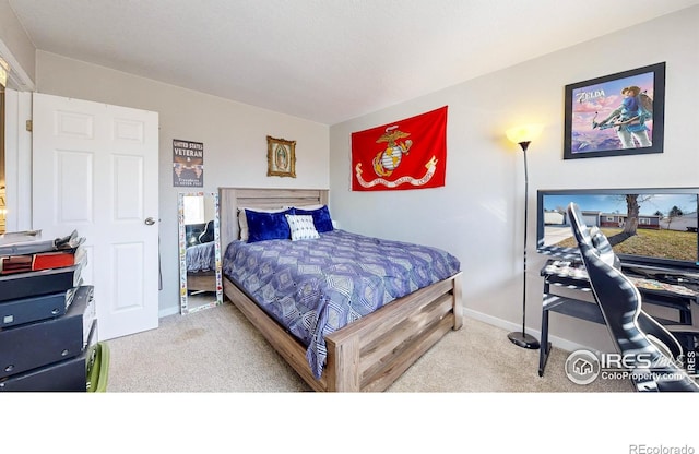 carpeted bedroom featuring baseboards