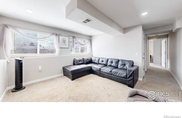 carpeted living room with visible vents, recessed lighting, and baseboards