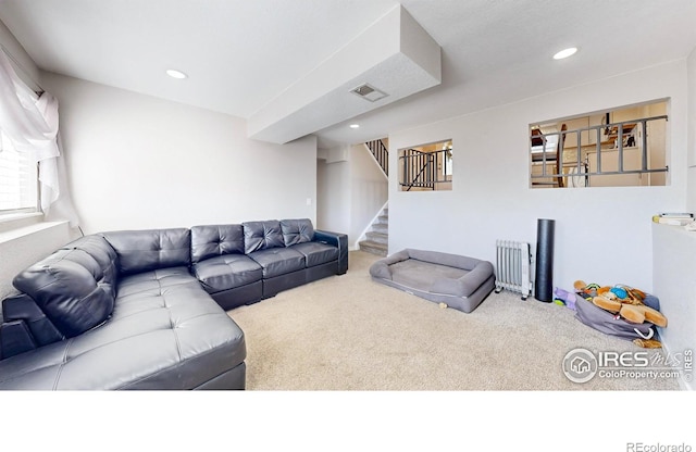 living room featuring recessed lighting, visible vents, carpet floors, and stairway