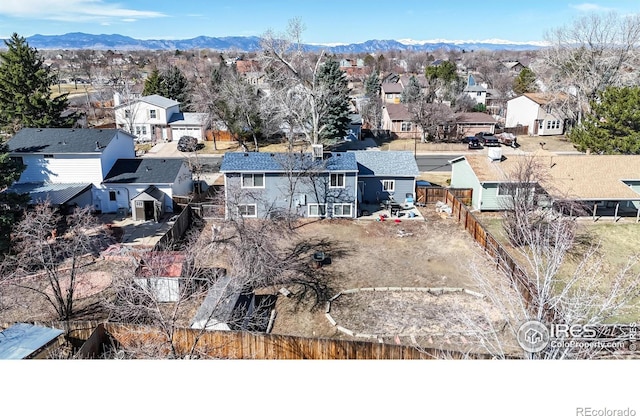 drone / aerial view featuring a residential view and a mountain view