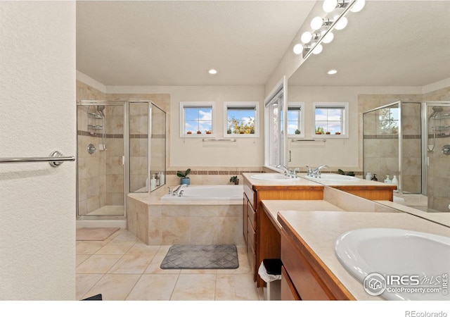 full bathroom with vanity, a shower stall, a bath, and tile patterned floors