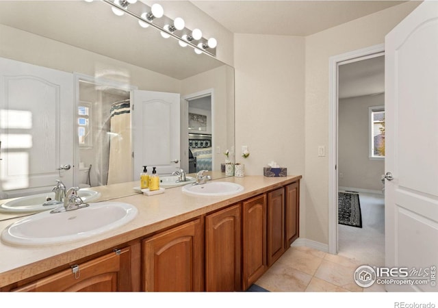 bathroom featuring double vanity, ensuite bath, a shower with curtain, and a sink