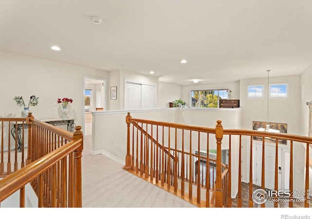 hallway featuring recessed lighting, an upstairs landing, and carpet floors