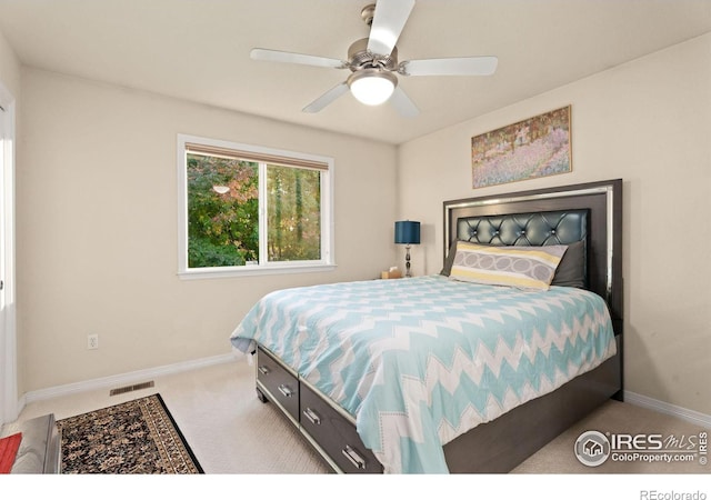 carpeted bedroom with visible vents, baseboards, and ceiling fan