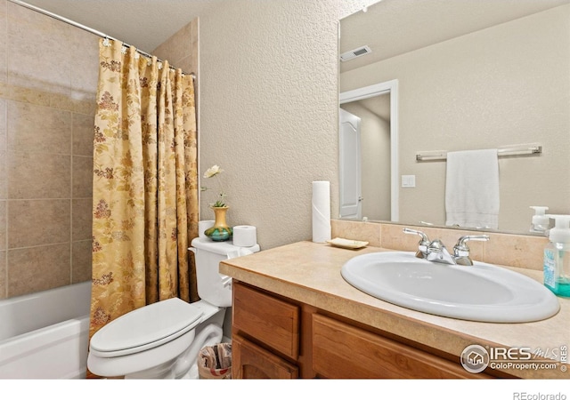 bathroom featuring vanity, shower / bathtub combination with curtain, visible vents, toilet, and a textured wall