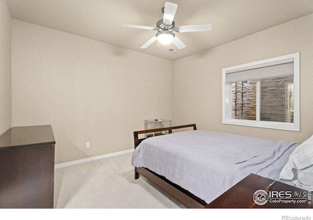 bedroom with baseboards, light carpet, and a ceiling fan