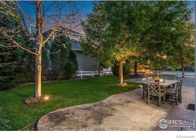 view of yard with outdoor dining area, a patio, and fence