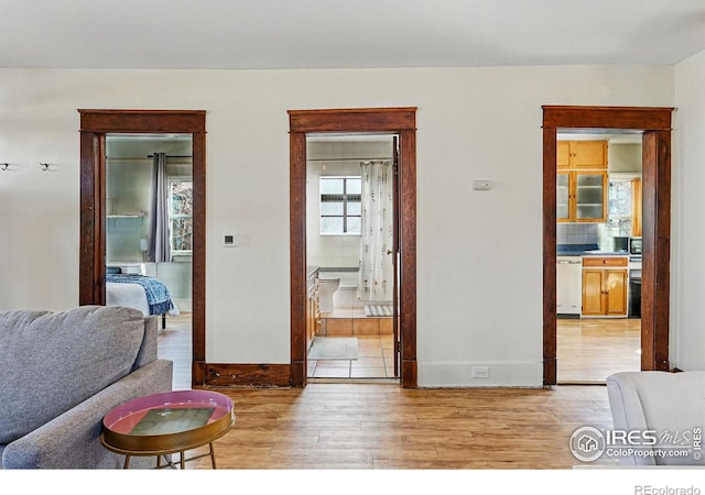 living room with light wood-type flooring and baseboards