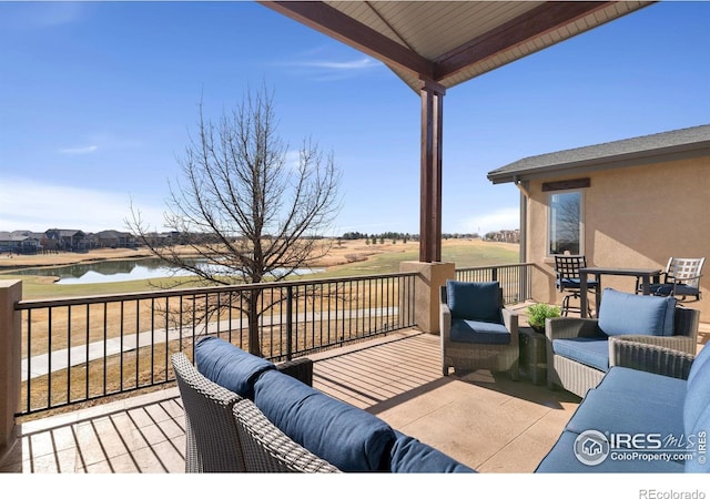 wooden deck with a water view and an outdoor hangout area