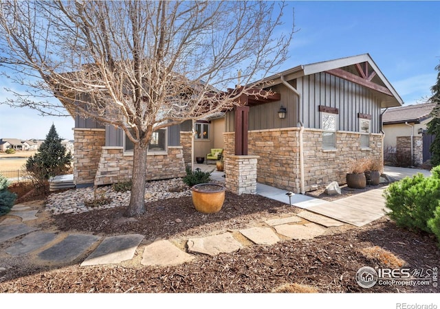 view of front facade featuring stone siding and board and batten siding