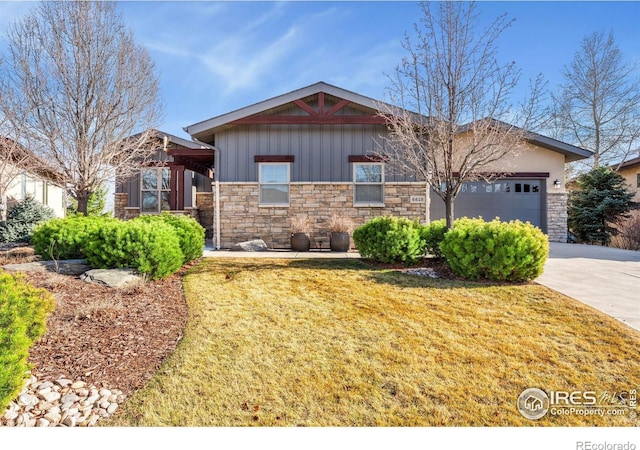 view of front of property with concrete driveway, a garage, stone siding, and a front lawn