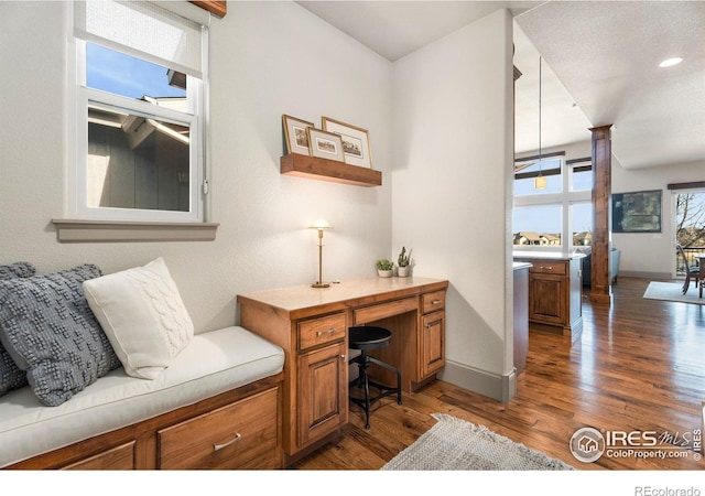 home office with wood finished floors and baseboards