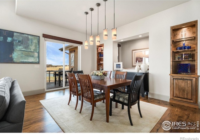 dining area with wood finished floors and baseboards