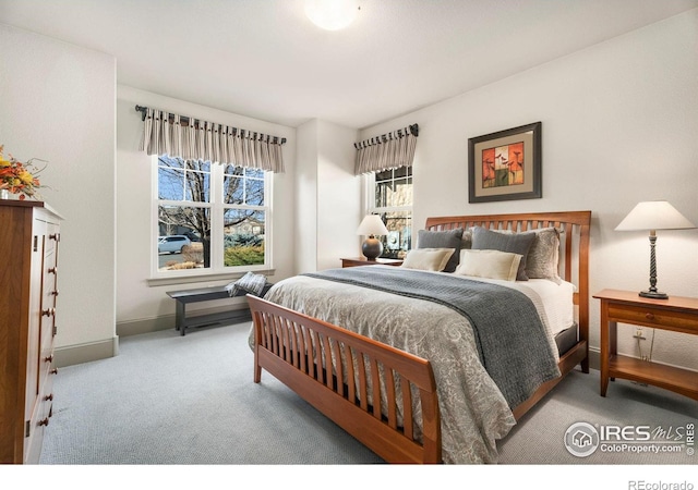 bedroom featuring carpet flooring and baseboards