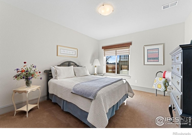 carpeted bedroom featuring baseboards and visible vents