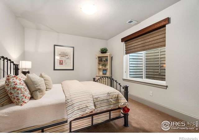 bedroom with visible vents, baseboards, and carpet