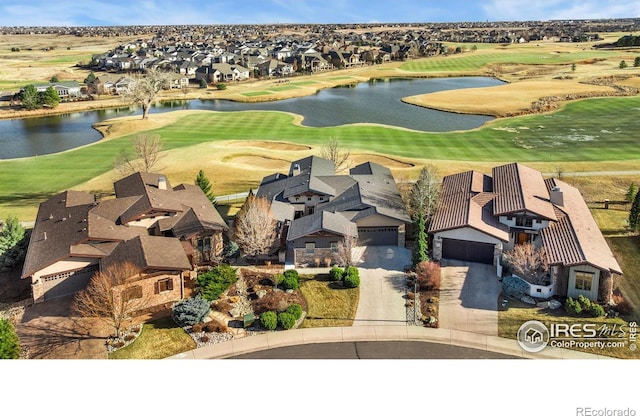 aerial view featuring a residential view, a water view, and view of golf course