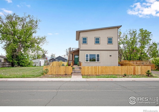 229 3rd St, Fort Collins, CO 80524 - modern home with a fenced front yard and stucco siding