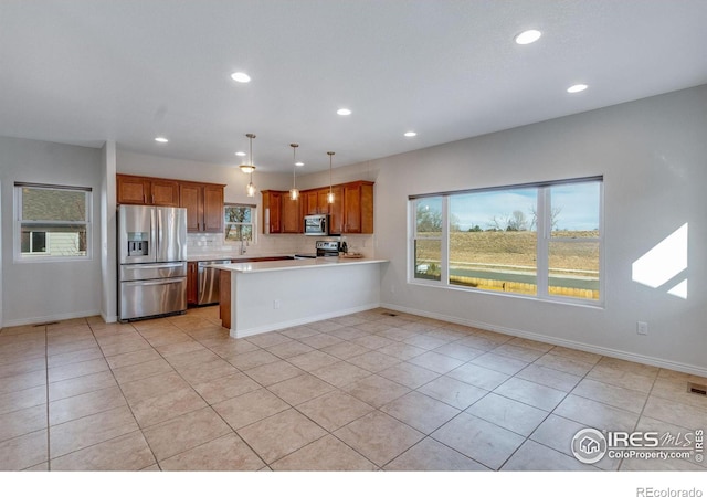 229 3rd St, Fort Collins, CO 80524 - kitchen featuring stainless steel appliances, light countertops, recessed lighting, a peninsula, and light tile patterned flooring