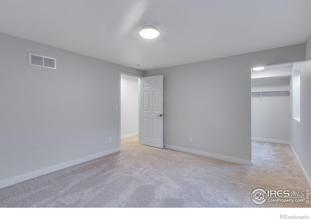 229 3rd St, Fort Collins, CO 80524 - unfurnished bedroom featuring light colored carpet, baseboards, and a walk in closet