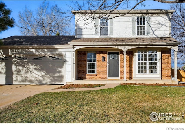 traditional-style home with a front yard, brick siding, concrete driveway, and an attached garage