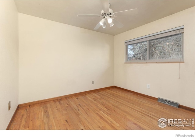 unfurnished room with visible vents, baseboards, ceiling fan, and light wood finished floors