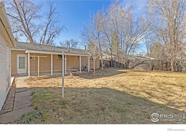 view of yard featuring a patio and fence